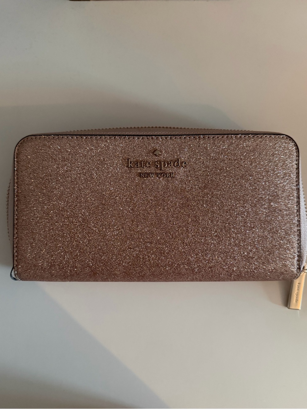 kate spade glitter zip-around wallet in rose gold